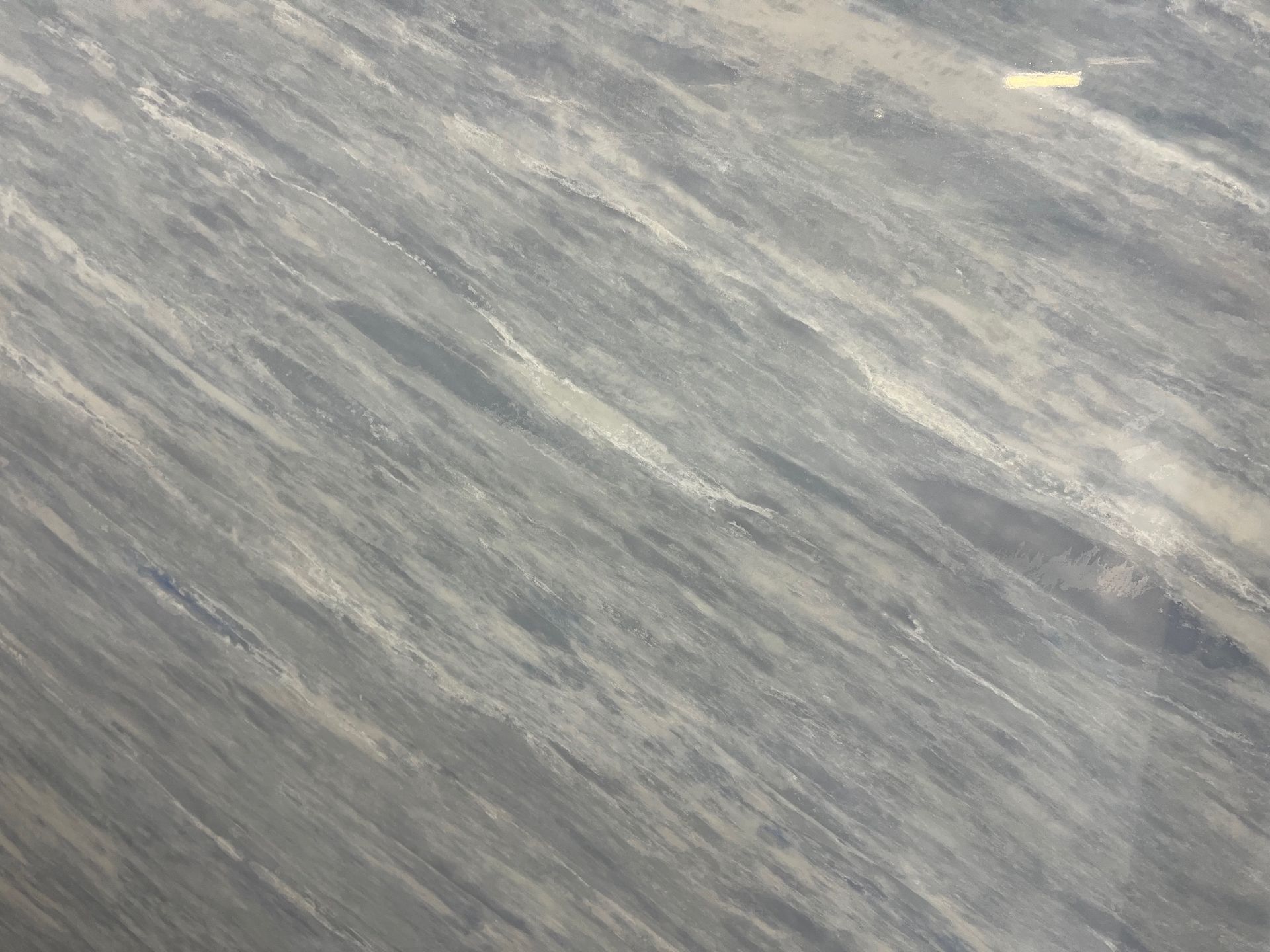 Gray rippled water surface with light reflections