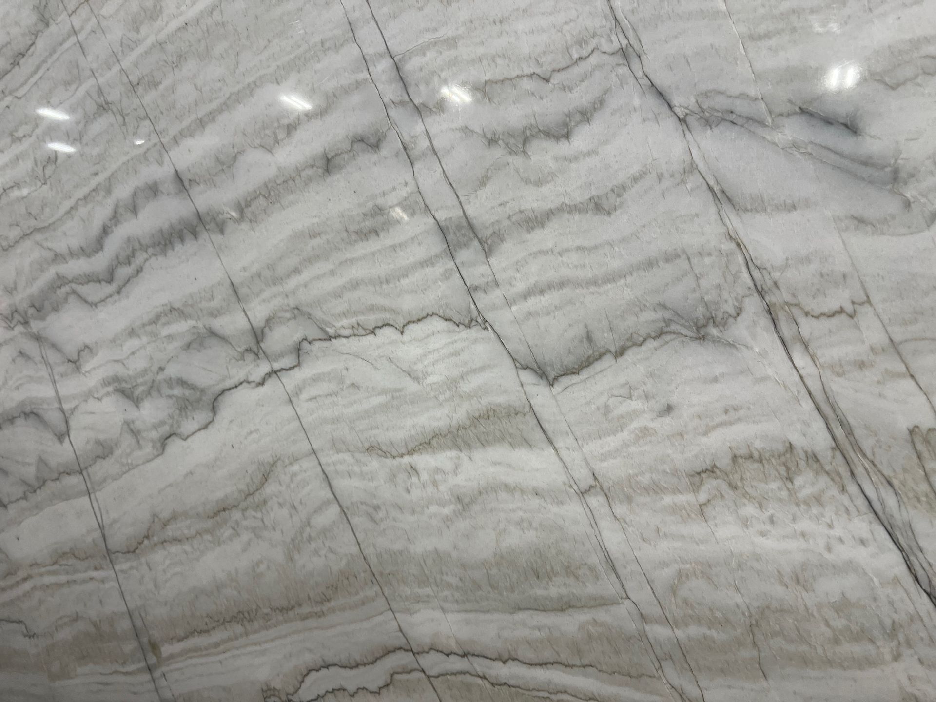 Gray and white marble surface with subtle veining and diagonal seams
