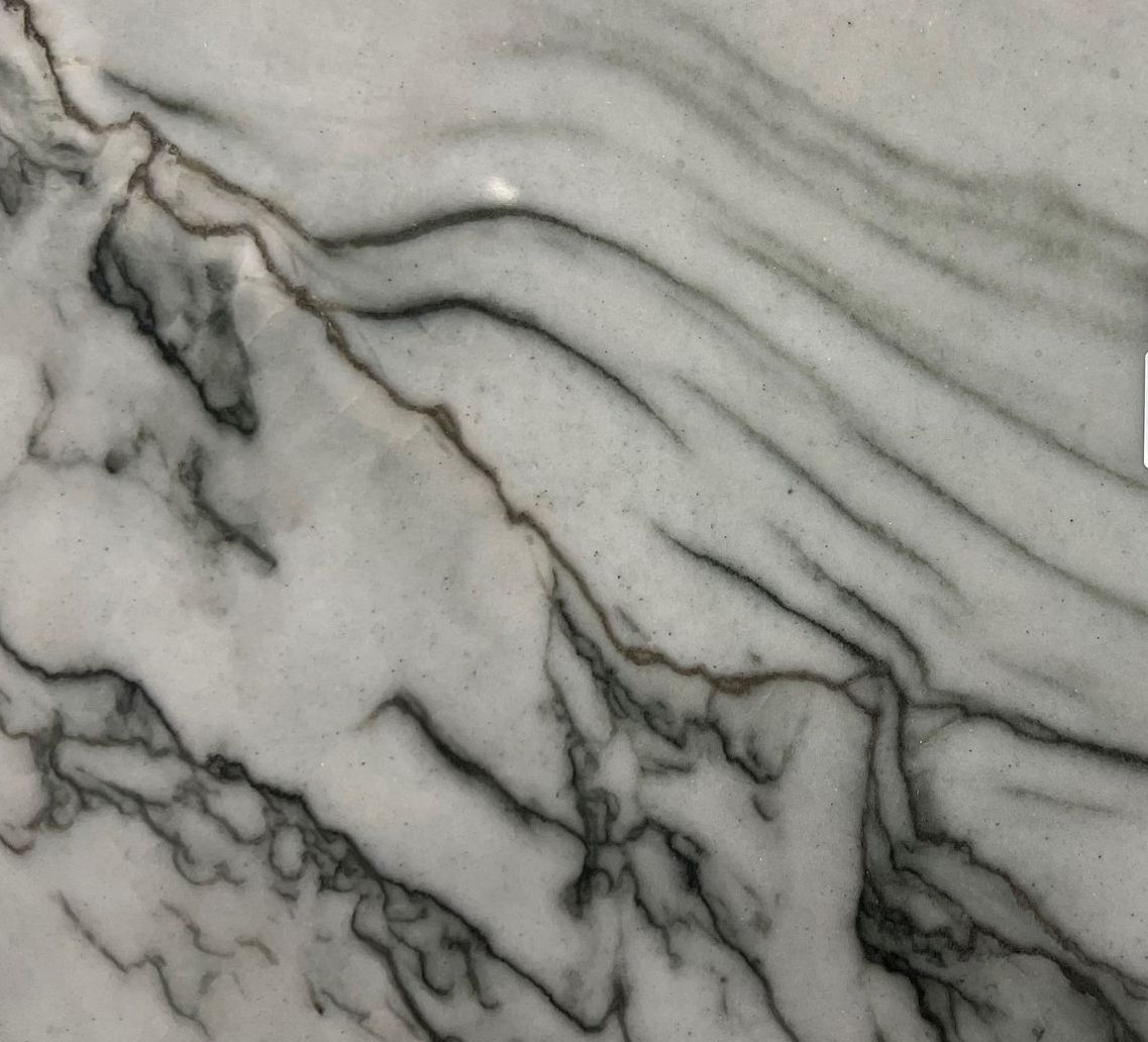 Gray marble surface with dark veining and diagonal streaks
