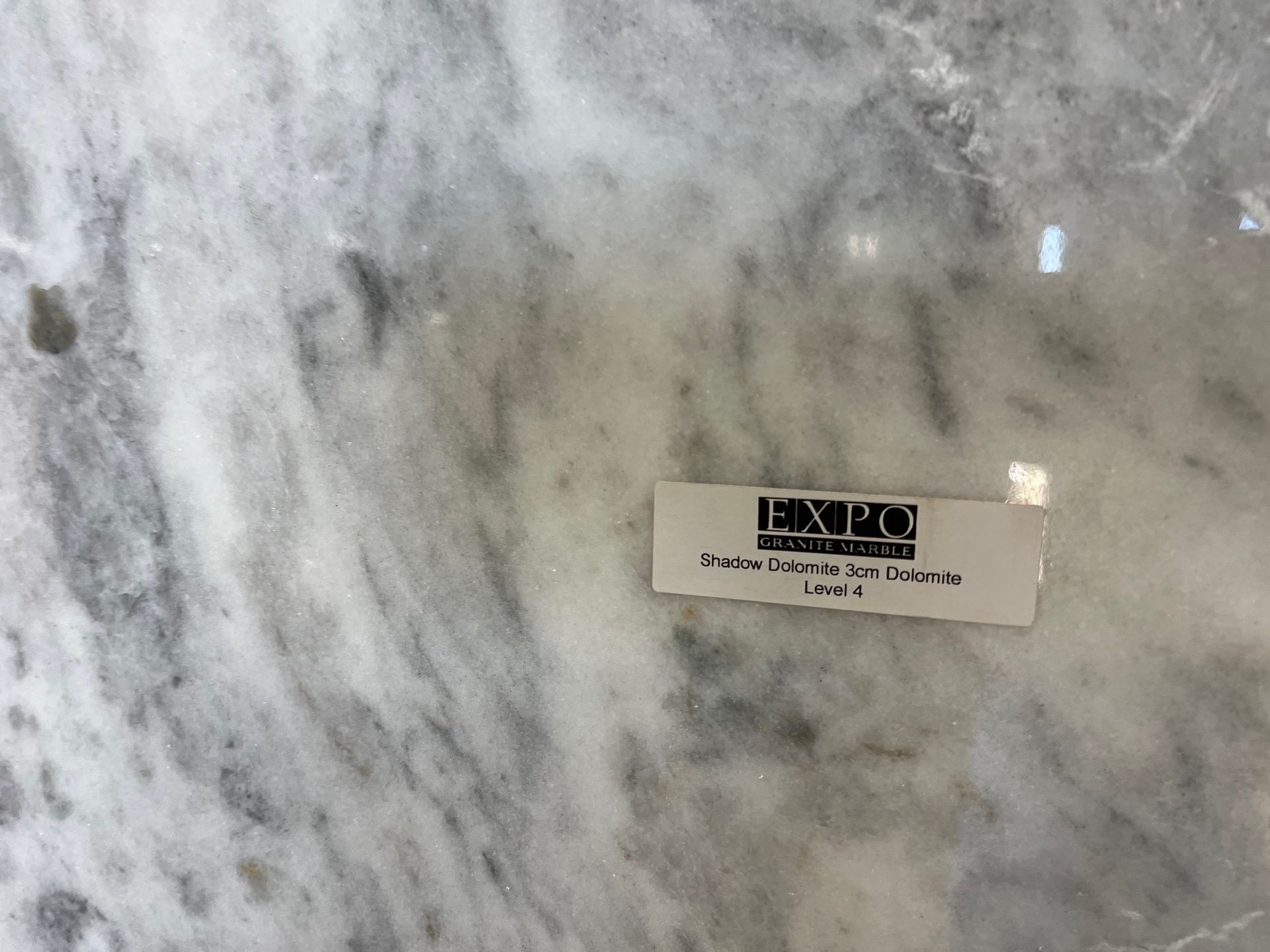 Marble countertop with a small Expo product label near the center-right.