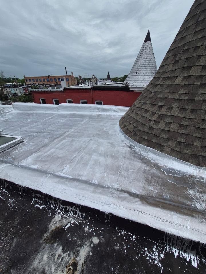 Snow-covered rooftop with conical towers under a cloudy sky