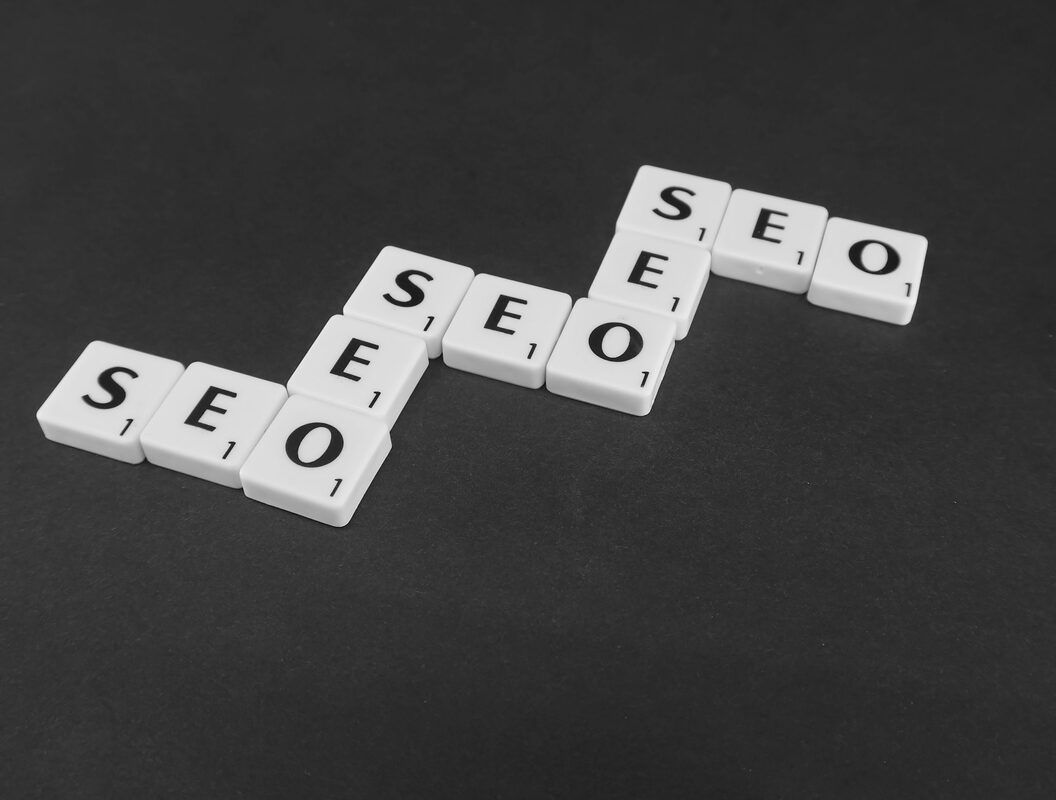 Scrabble tiles spelling out the word seo on a black surface