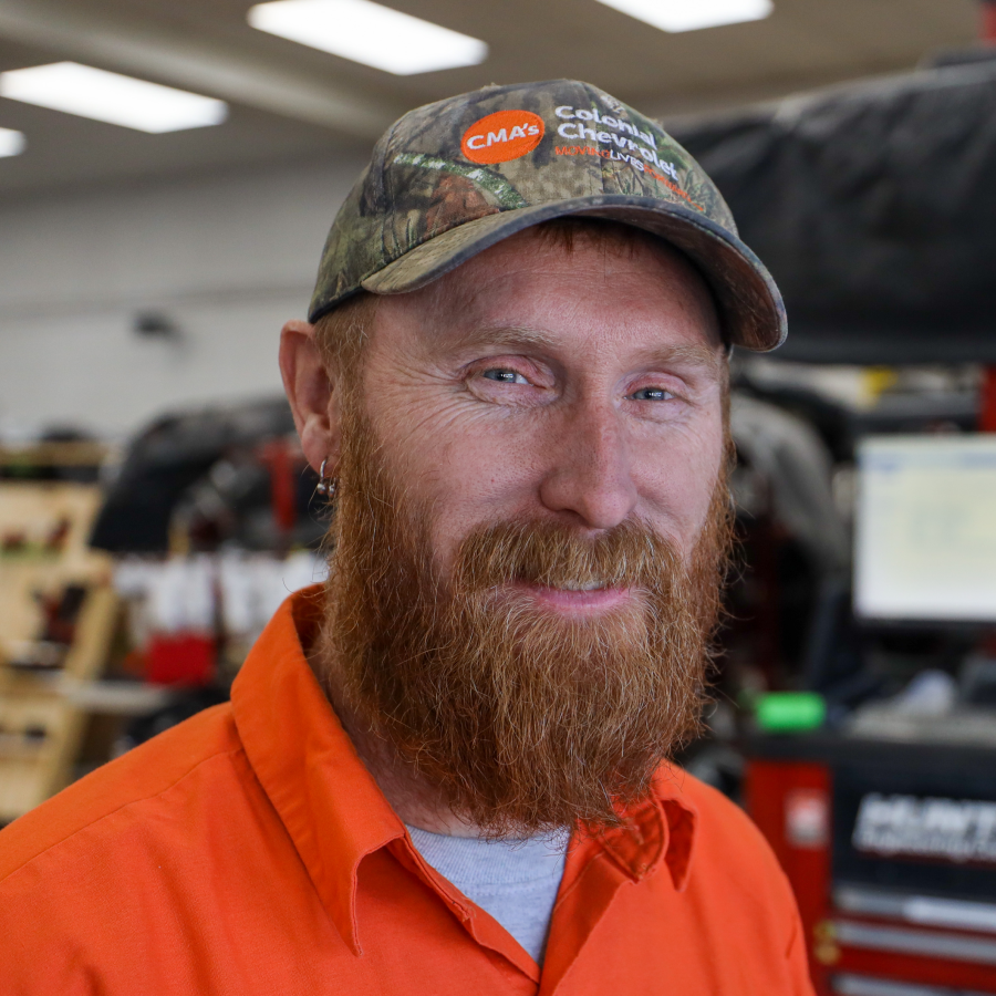 A man with a beard wearing a cna hat