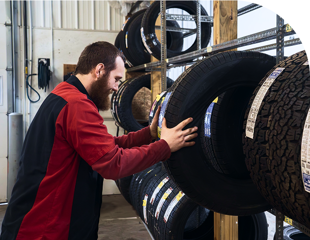 Mechanic holding a tire | Midwest Truck and Tire