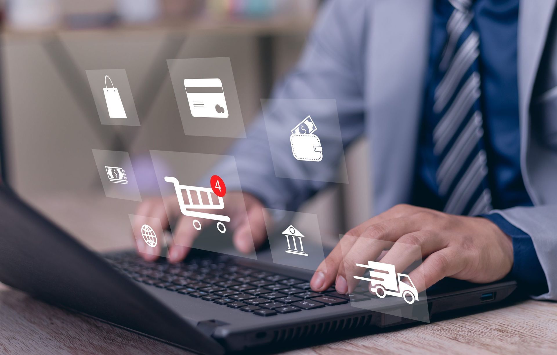 Businessman typing on laptop with e-commerce icons floating above it