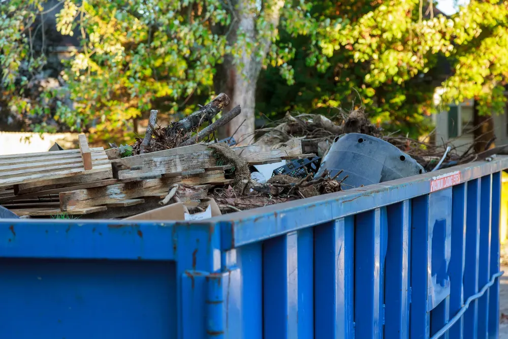 A Blue Skip Bin Full of Wooden Pallets — Select Site Solutions in Berry, NSW
