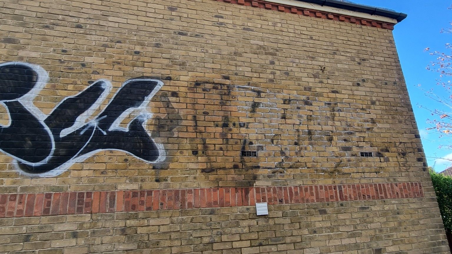 graffiti removal partial from brickwork