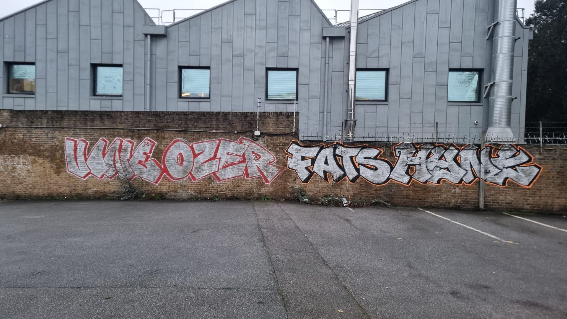 graffiti removal from an industrial commercial wall before