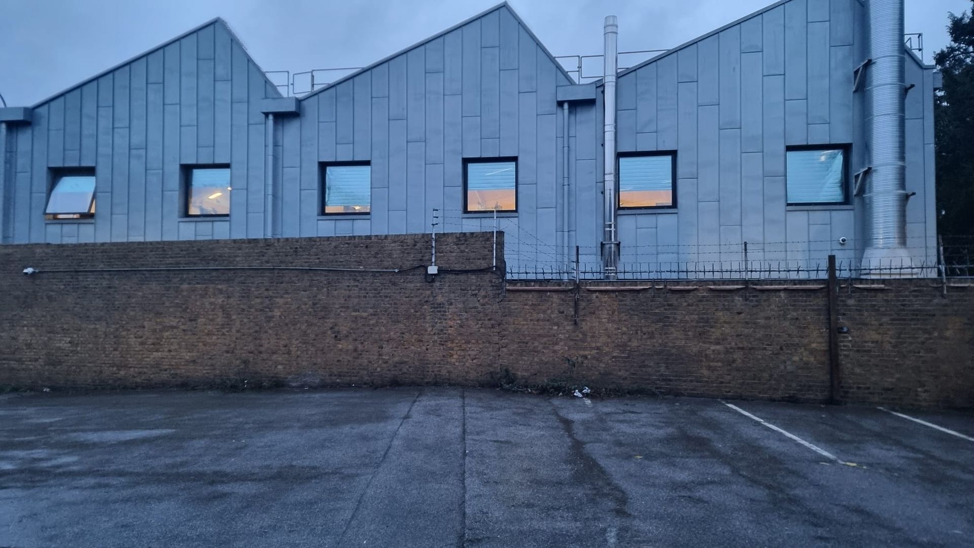 graffiti removal from an industrial commercial wall after