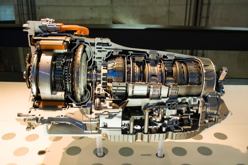 Cutaway view of a jet engine on display in a museum, showing internal components.