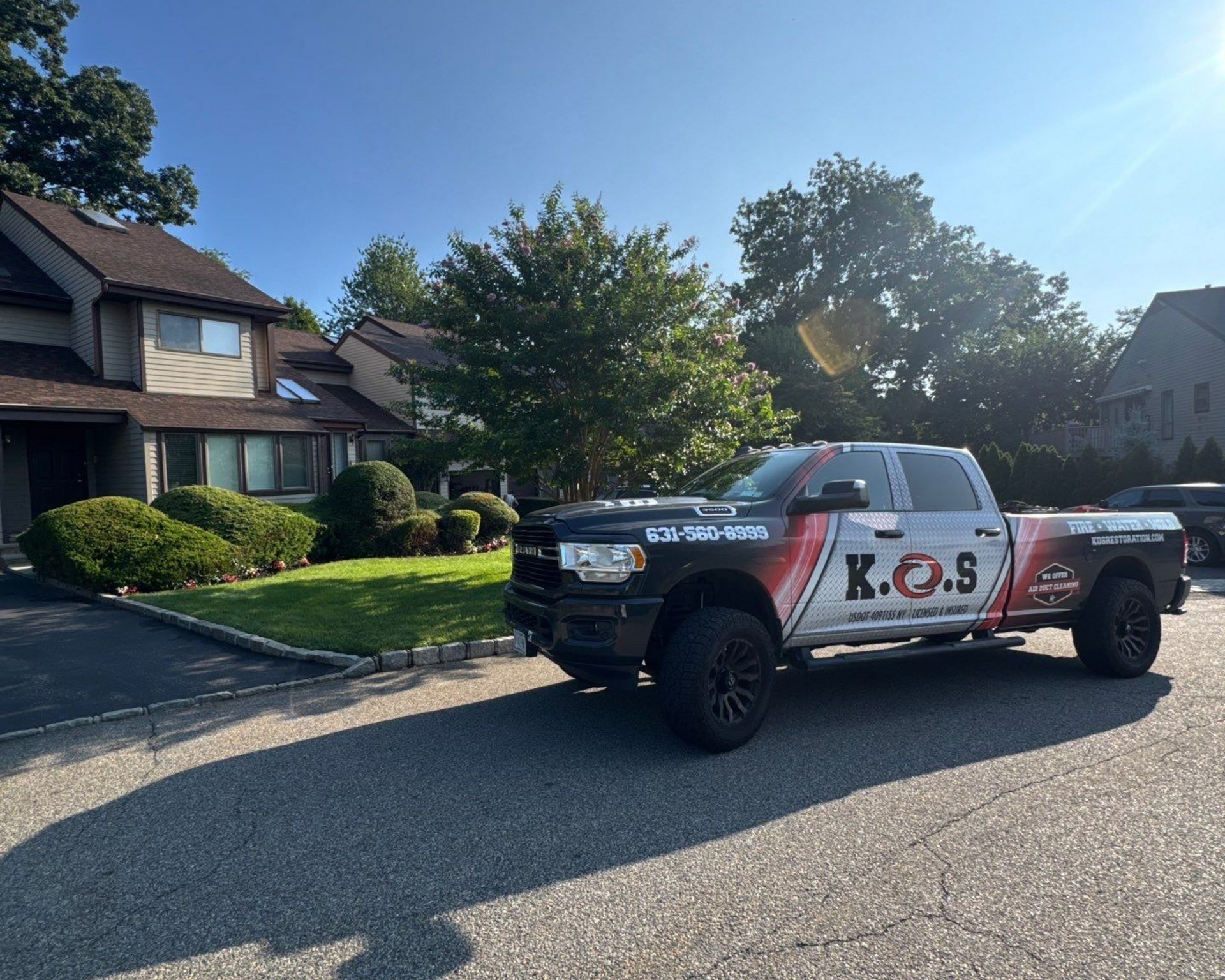 K.O.S. Restoration technician performing water damage restoration and mold remediation in Glen Head, NY