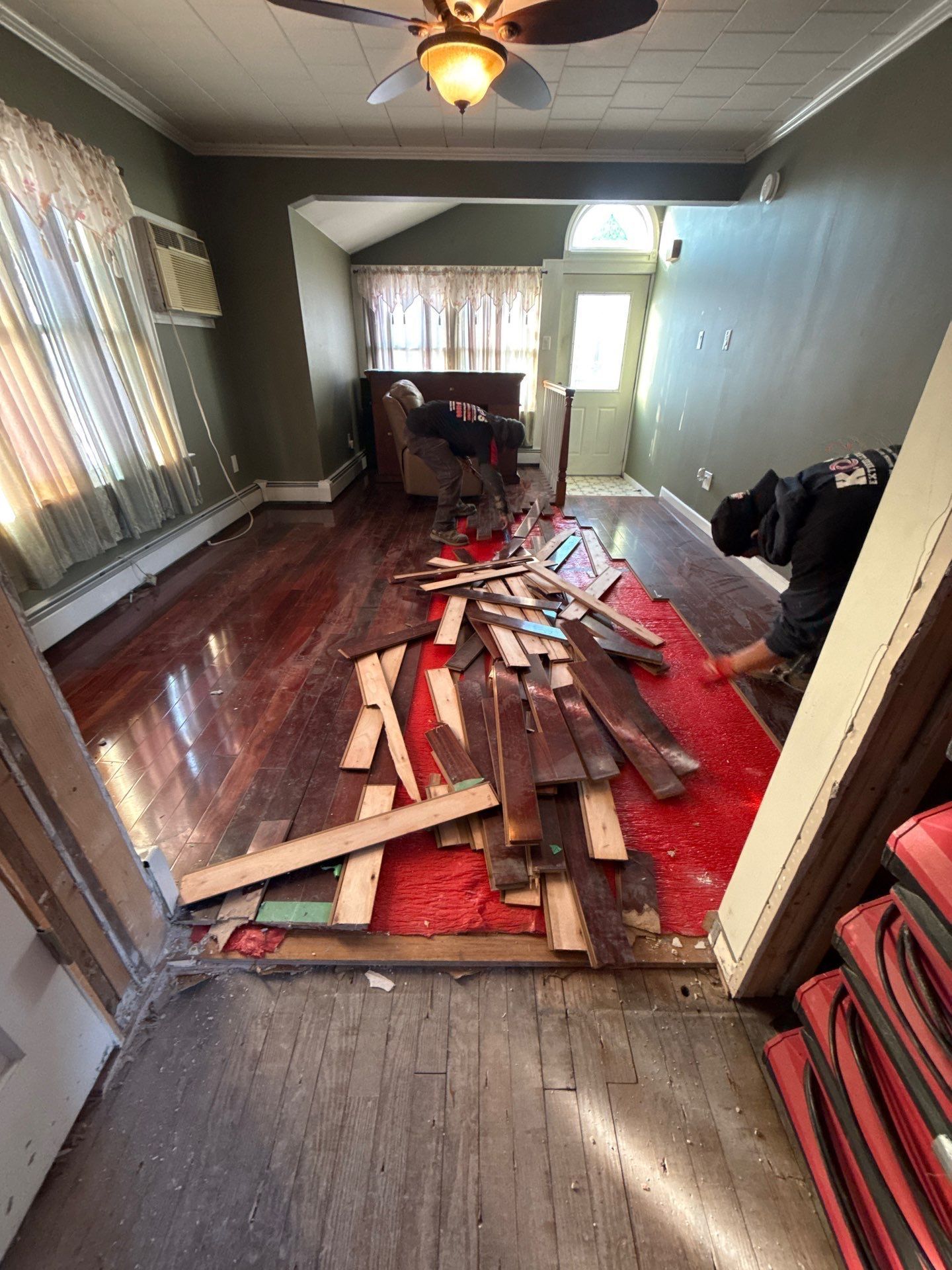 Removing water damaged wood flooring at a home in Patchogue NY
