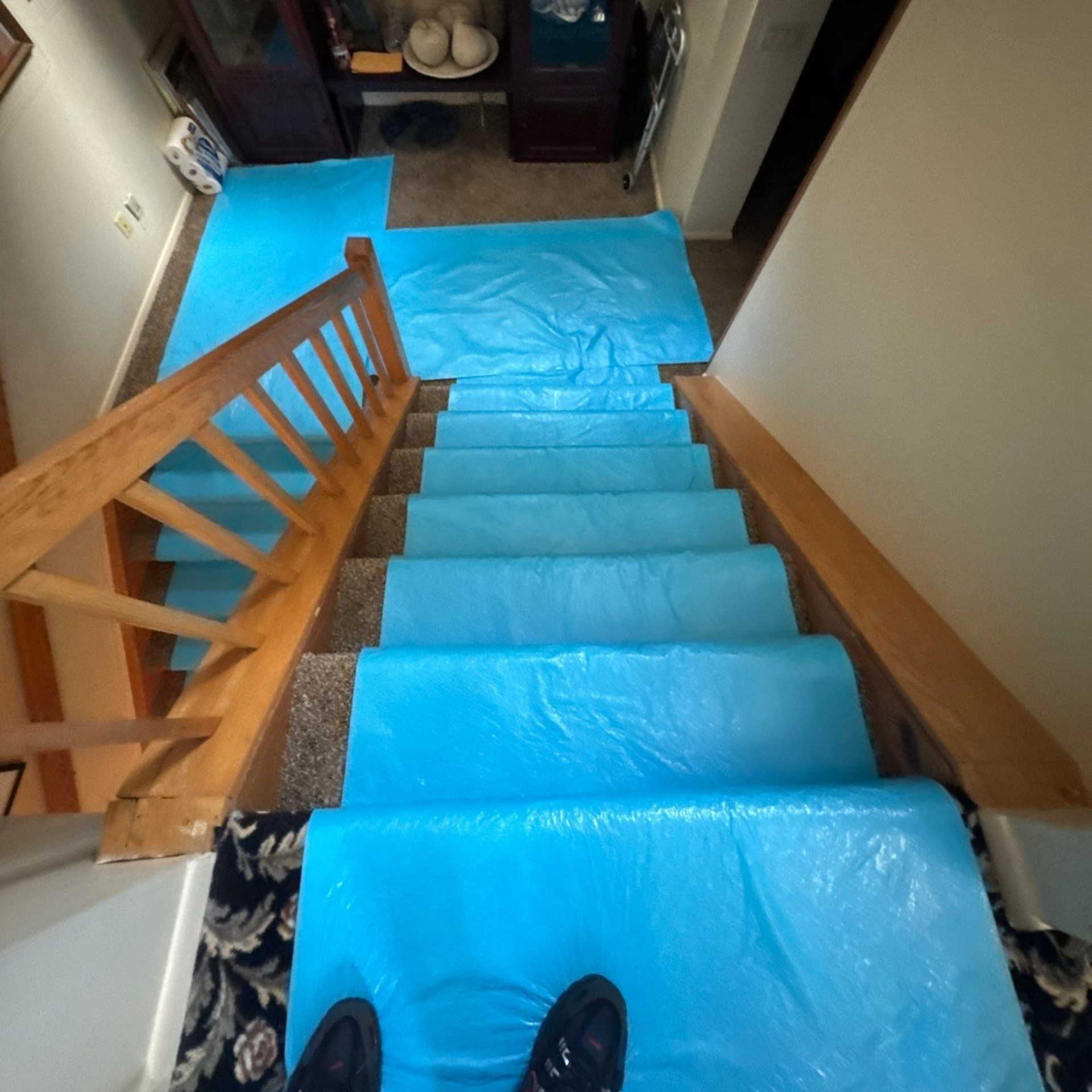 Protective covering on flooring at Glen Head home after water damage.