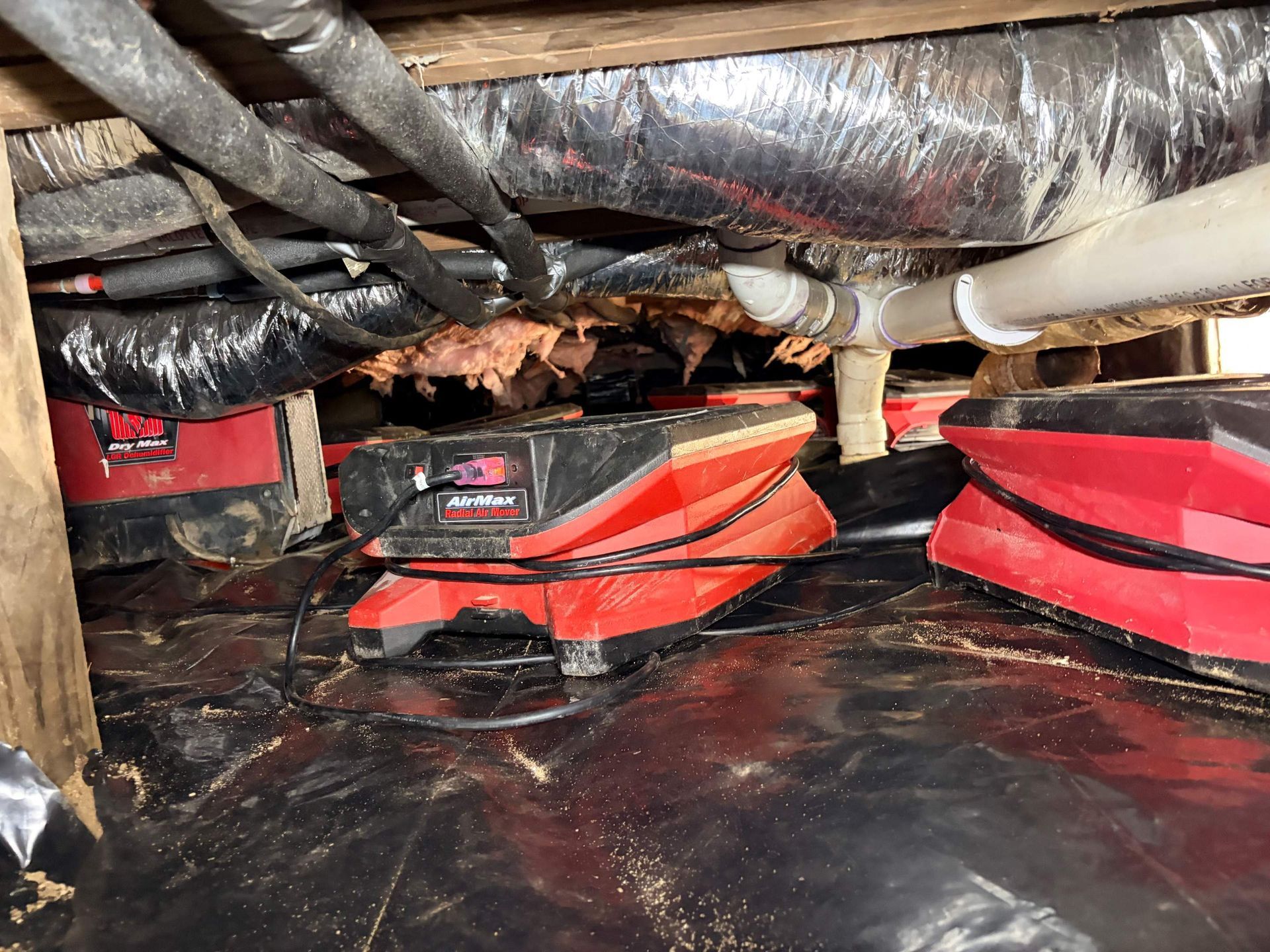 Drying and dehumidifying equipment installed at a home in Westhampton Beach, NY after sewage flood in crawlspace.
