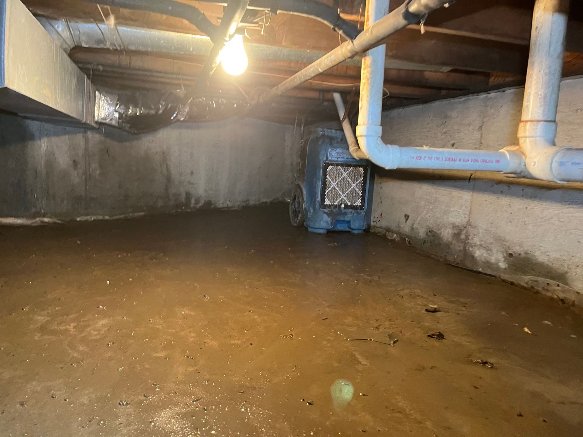 Flooded crawlspace with drying and dehumidifying equipment after flood at home in Westhampton Beach NY