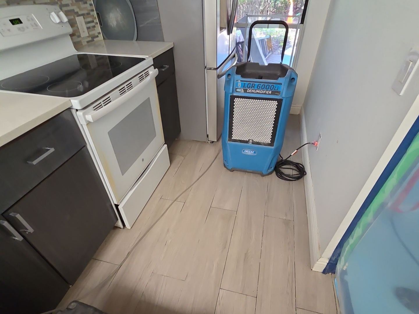 Drying and dehumidifying equipment setup in kitchen after flood at home in Westhampton Beach NY