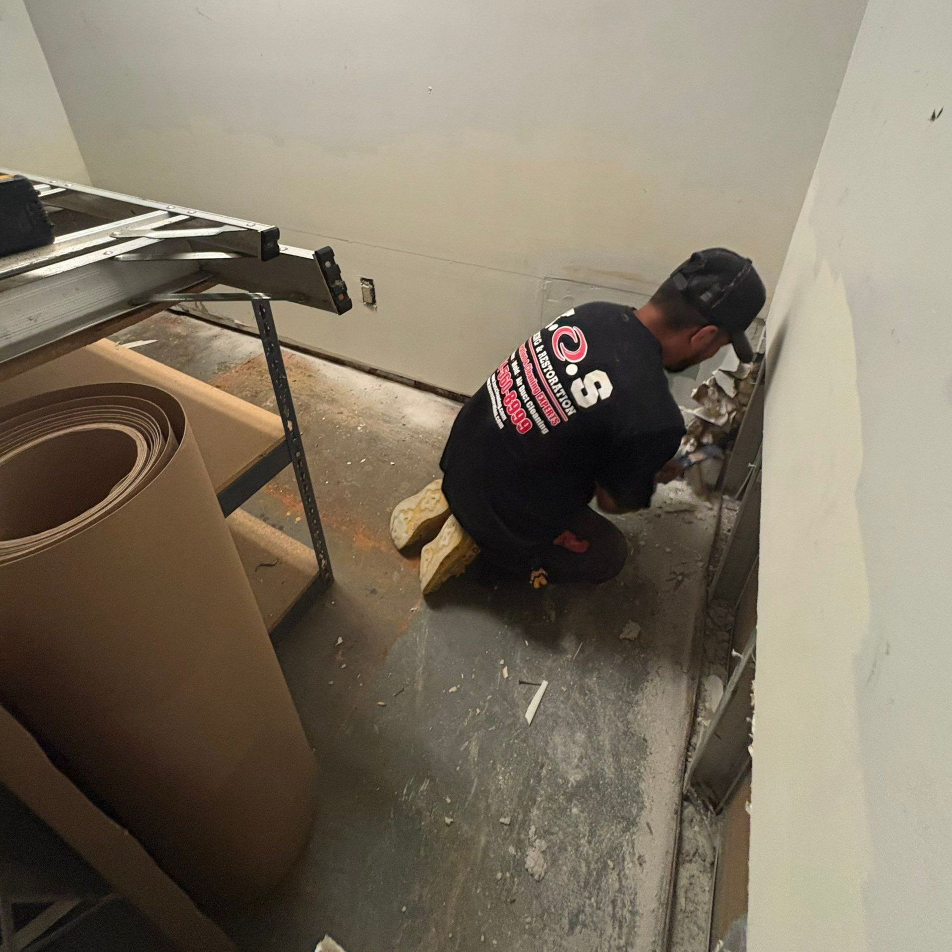 removing drywall in basement at Glen Head home after water damage.