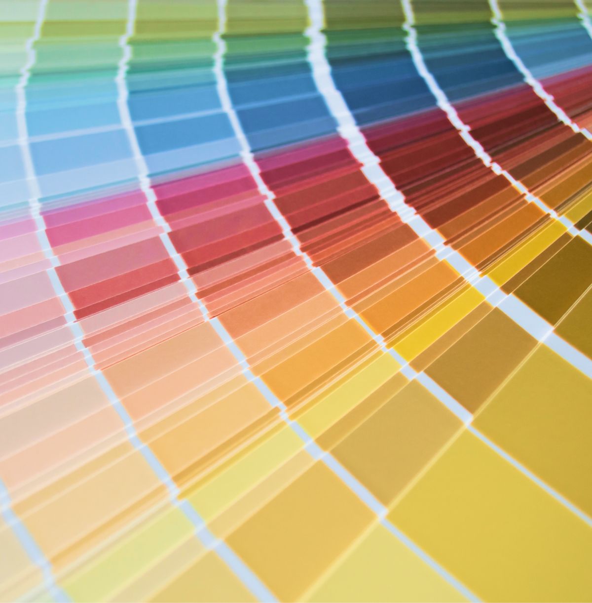 Curved fan of multicolored paint swatches with white dividers, fading from blue to yellow