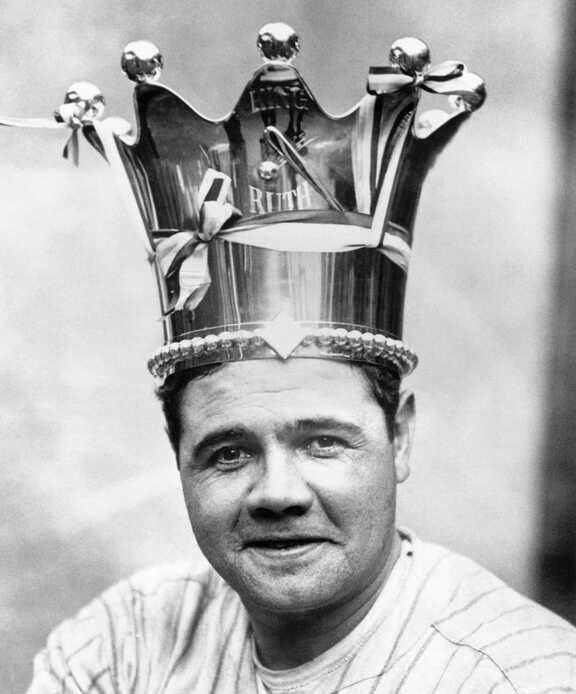 A man wearing a crown with the letter r on it