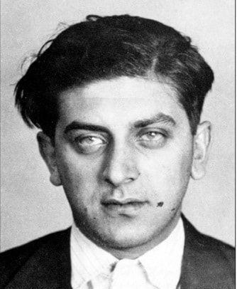 A black and white photo of a man in a suit and tie.