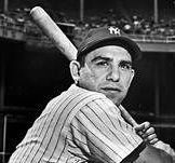 A black and white photo of a baseball player holding a bat.