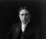 A black and white photo of a man in a suit and tie.