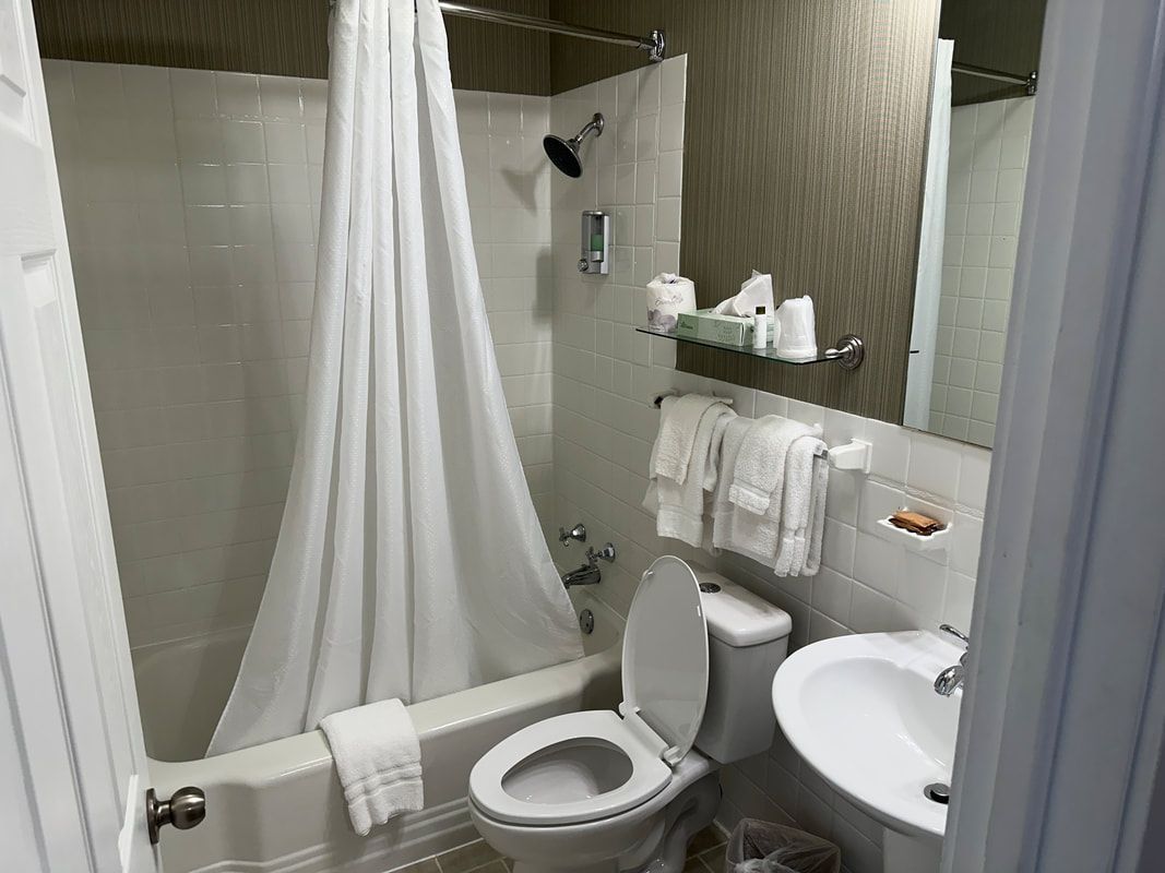 A bathroom with a toilet , sink and bathtub