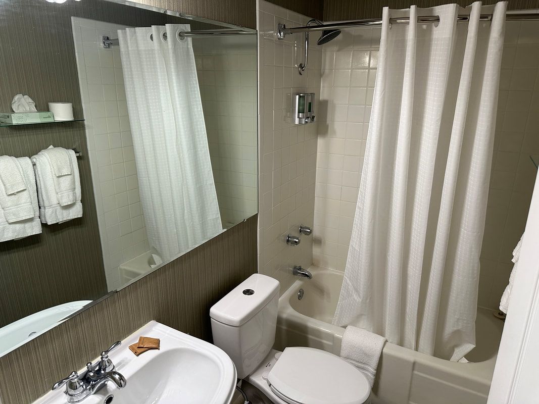 A bathroom with a toilet , sink and bathtub