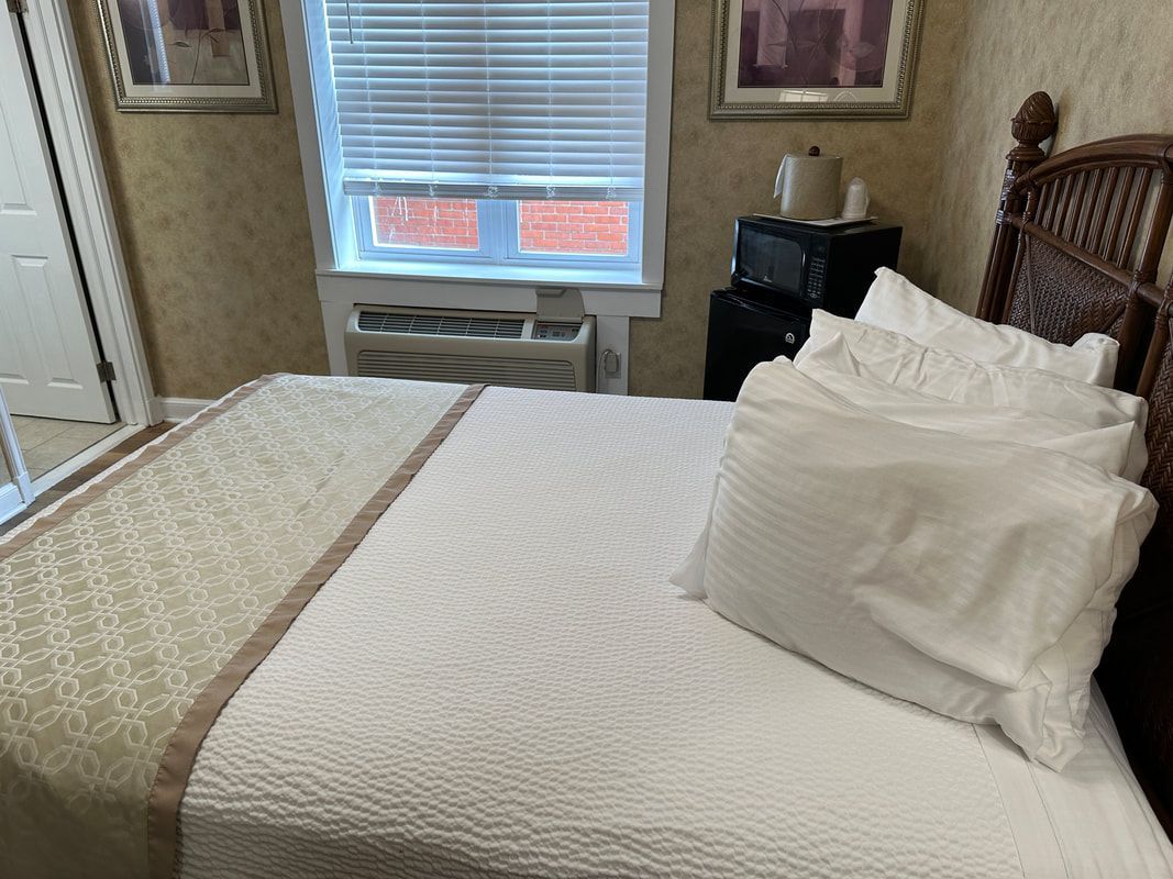 A hotel room with a bed and a window