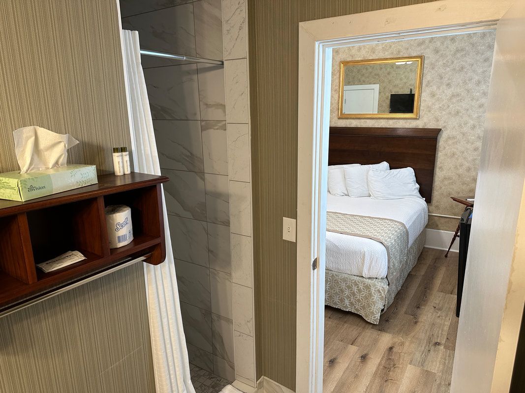 A hotel room with a bed and a bathroom.