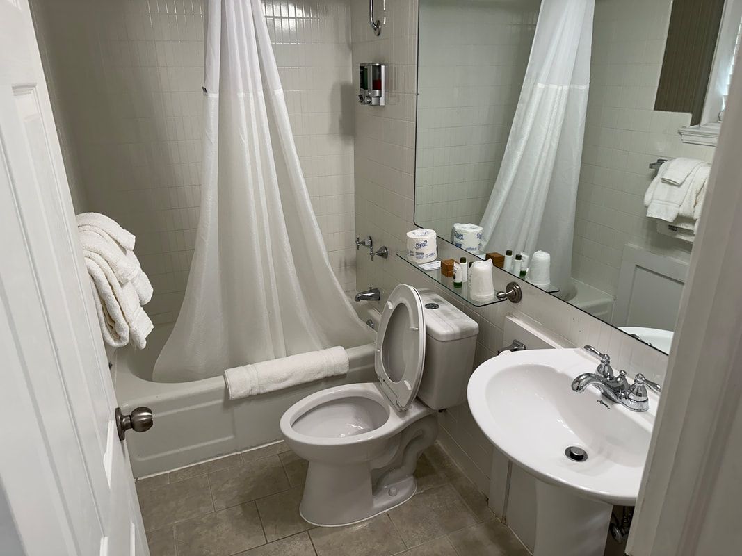A bathroom with a toilet , sink and bathtub