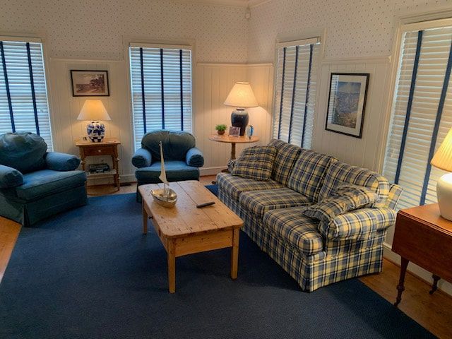 A living room with a couch and two chairs