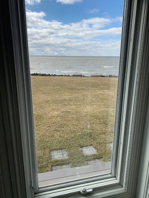 A view of the ocean from a window in a house.