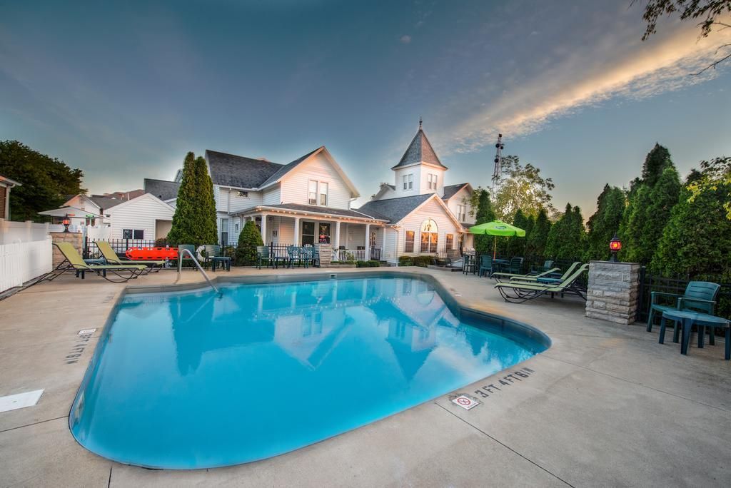 A large swimming pool in front of a house