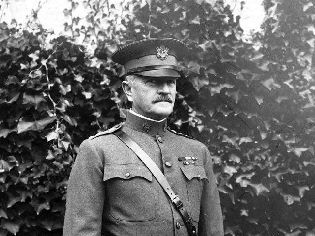 A black and white photo of a man in a military uniform