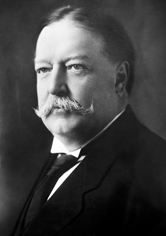 A man with a mustache is wearing a suit and tie