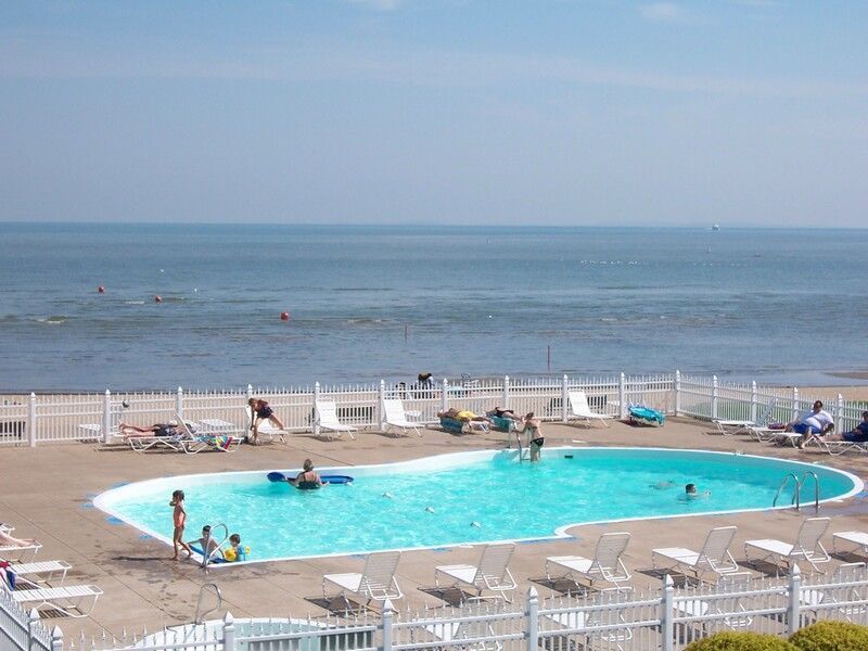 A large swimming pool with a view of the ocean