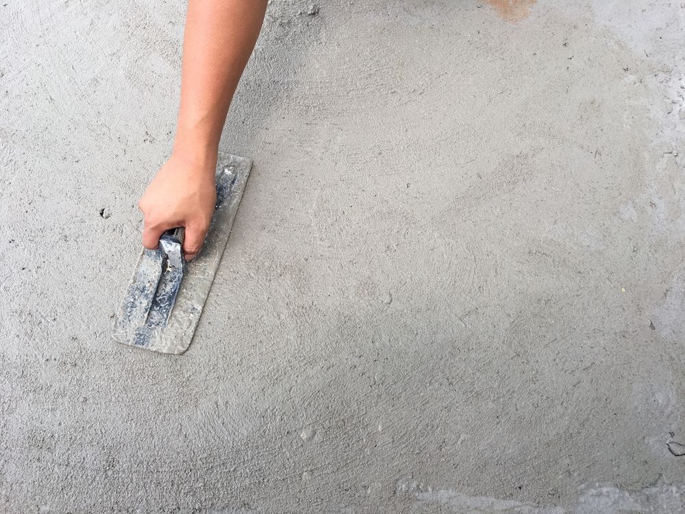 Hand Smoothing Wet Concrete with A Trowel — Rendering By Yilmaz P/L In Wollongong, NSW