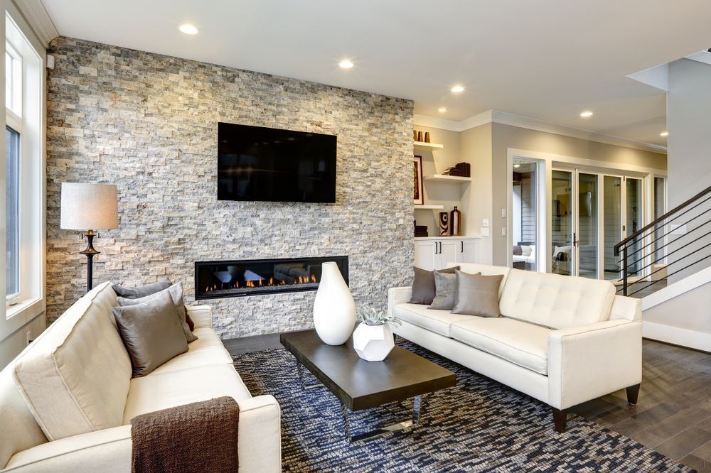 A Living Room With Two Couches, a Fireplace and a Flat Screen Tv — Suncoast Kitchens In Tanawha, QLD