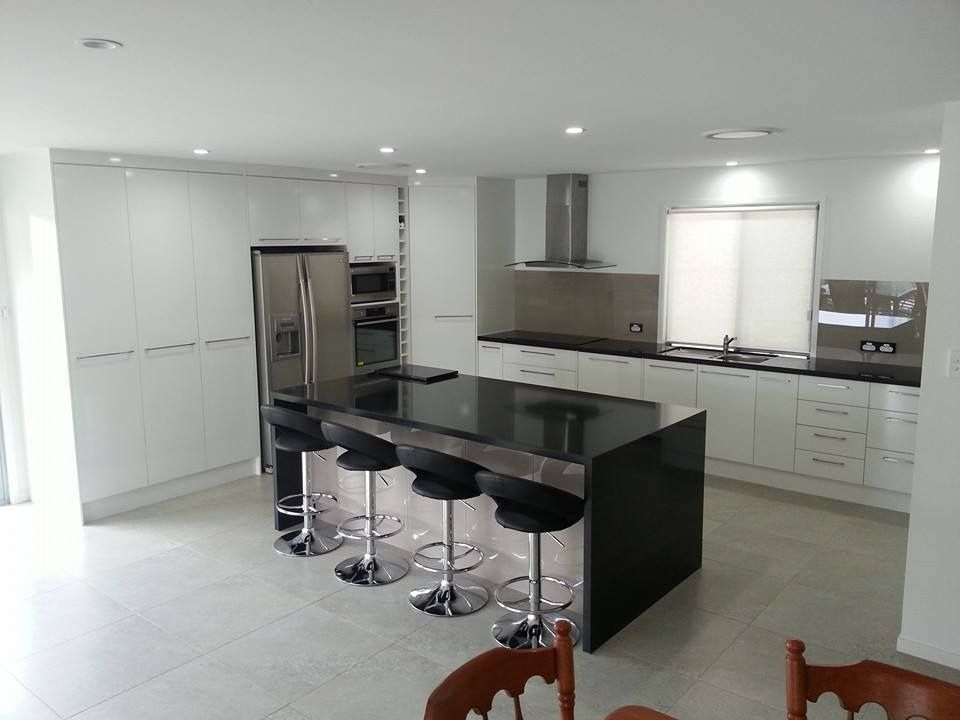 A Kitchen With White Cabinets and Black Counter Tops — Suncoast Kitchens In Kunda Park, QLD