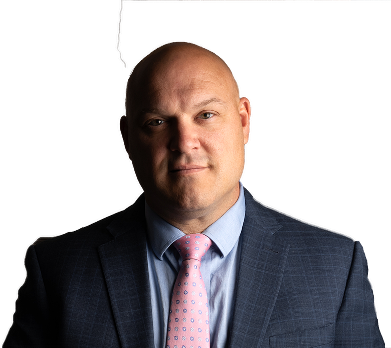 A bald man in a suit and tie is looking at the camera.