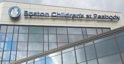 Exterior of Boston Children's at Peabody, with blue signage on a modern building.