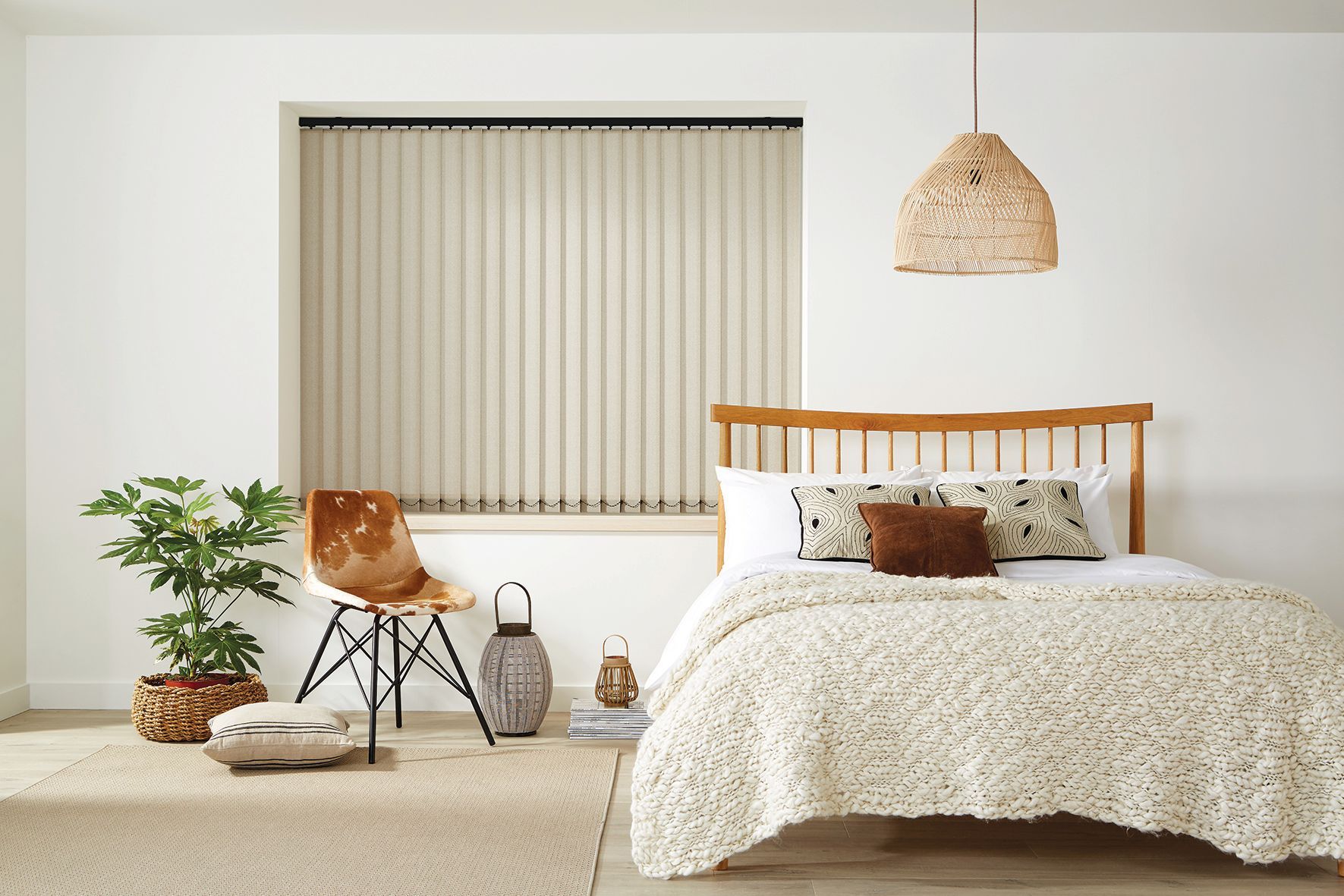 Bedroom with neutral tones; bed, window with blinds, chair, plant, woven pendant light, and rug. Abundance Blinds In Charmhaven, NSW