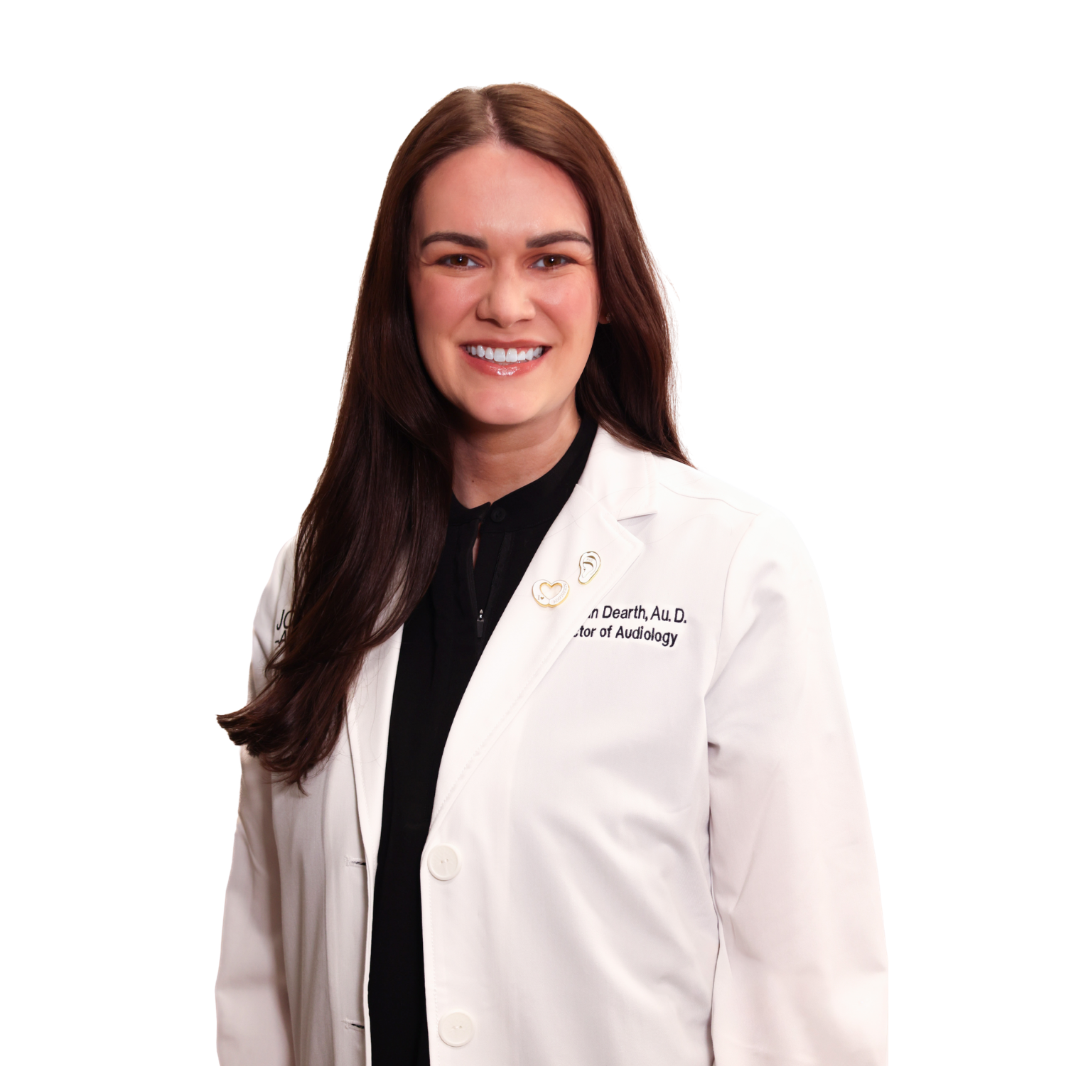 A woman in a white lab coat is smiling for the camera.