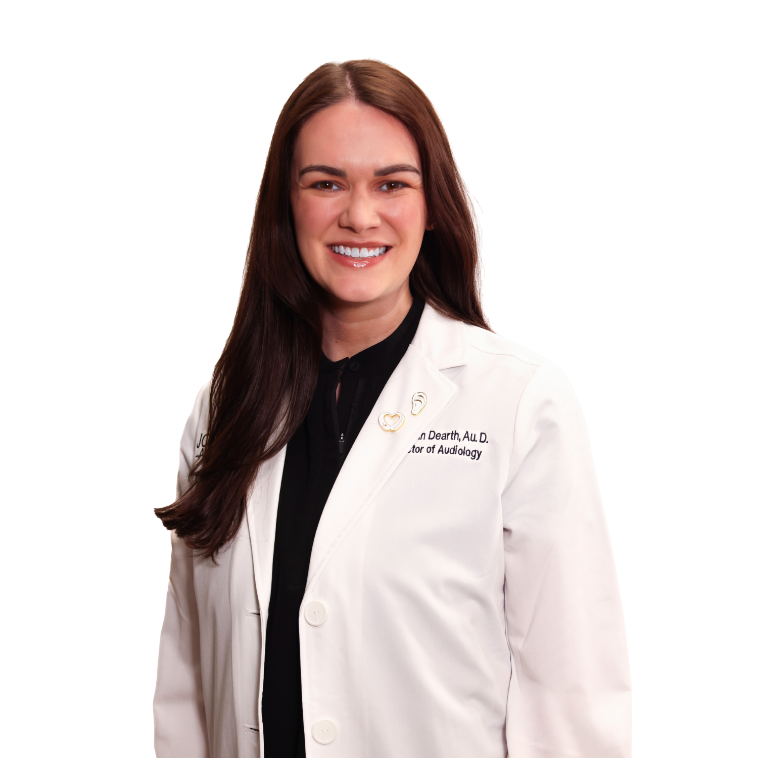 A woman in a white lab coat is smiling for the camera.