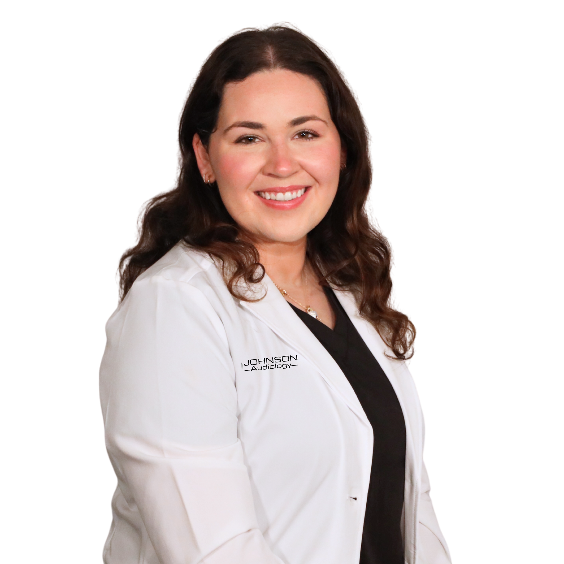 Woman with dark hair and a white lab coat smiles, looking directly at the viewer.
