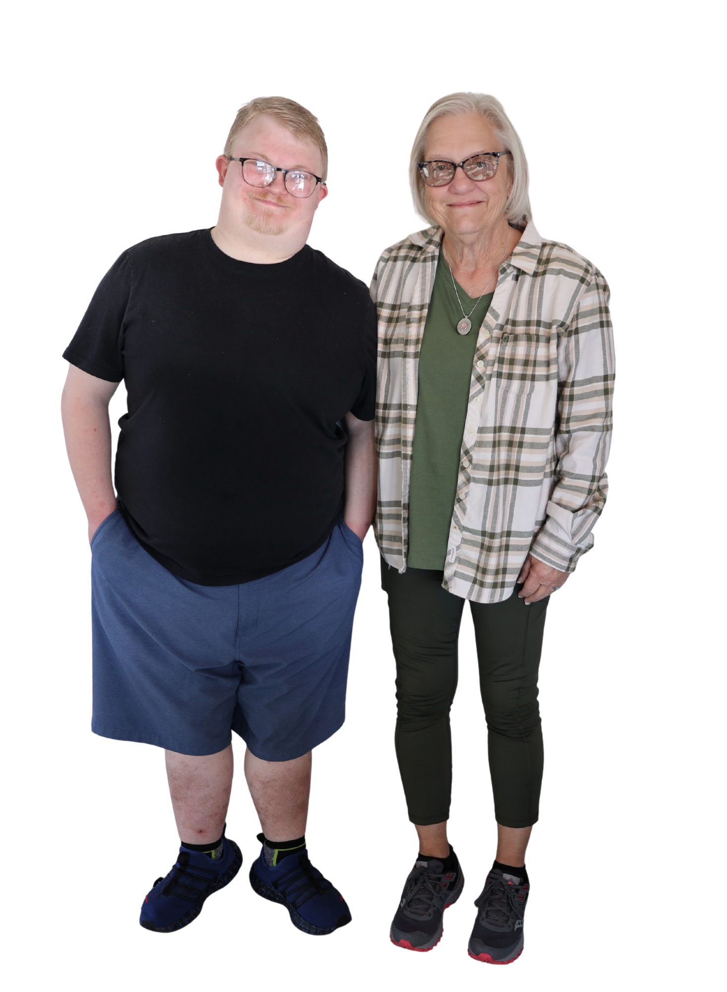 A person with glasses wearing a black shirt and blue shorts and a woman wearing a plaid shirt and green leggings.