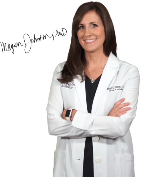 Woman in white lab coat with arms crossed, smiling against a white background.