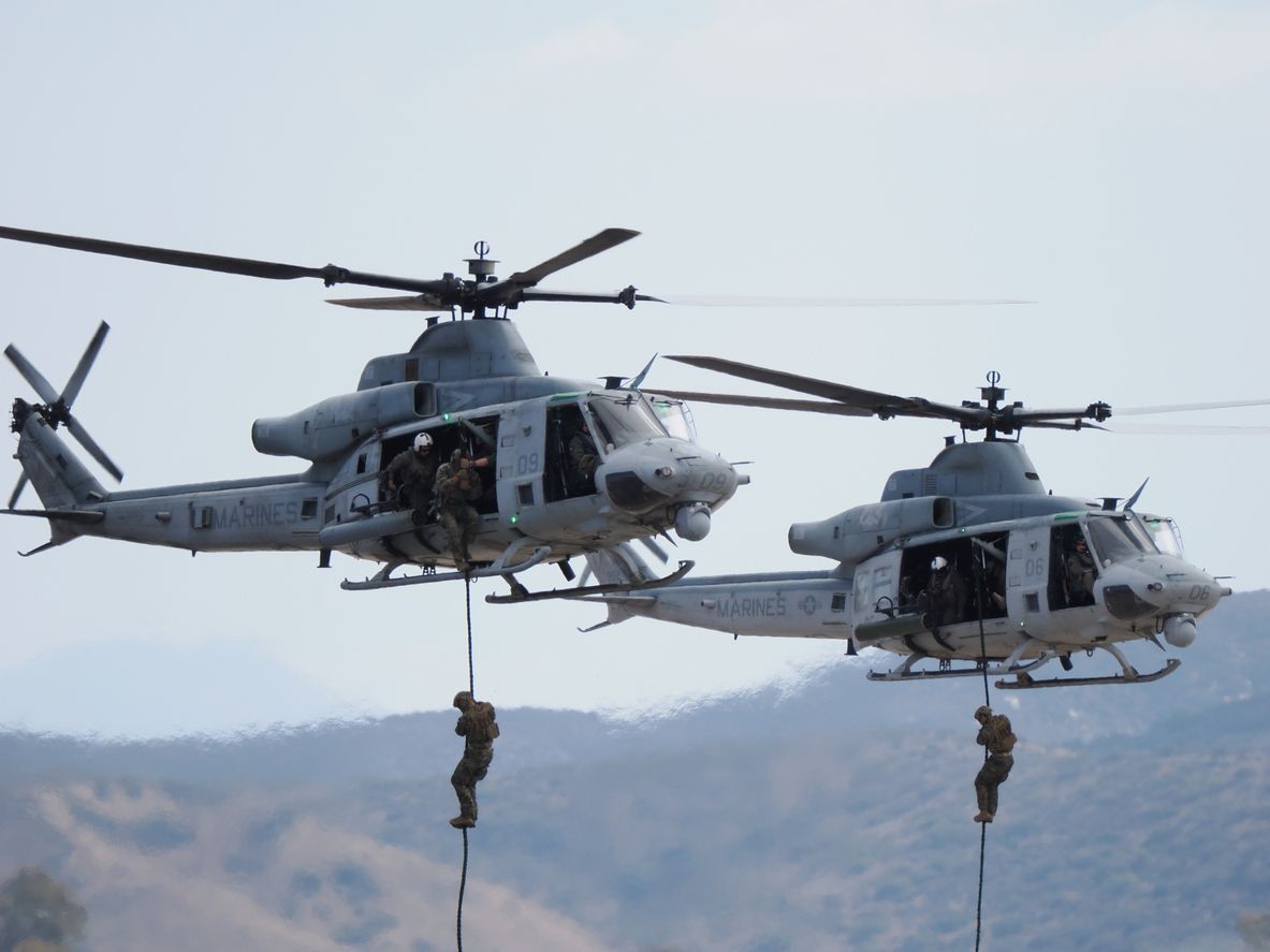 United States Marines dropping from a helicopter to show noise exposure.