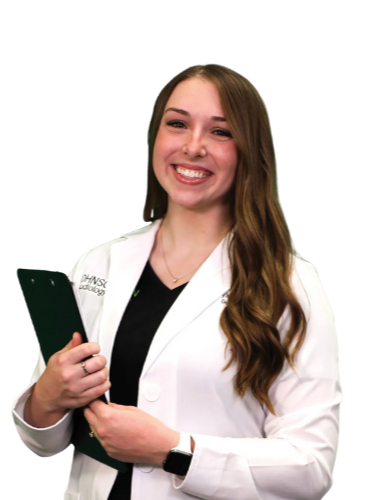 A woman in a lab coat is holding a clipboard and smiling.